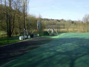 Step 4 of repairing a tennis court, repainting the tennis court and the surround.