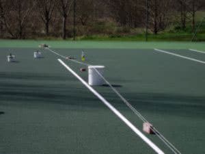 Step 7 of the tennis court repair. making sure the lines are exact and dry