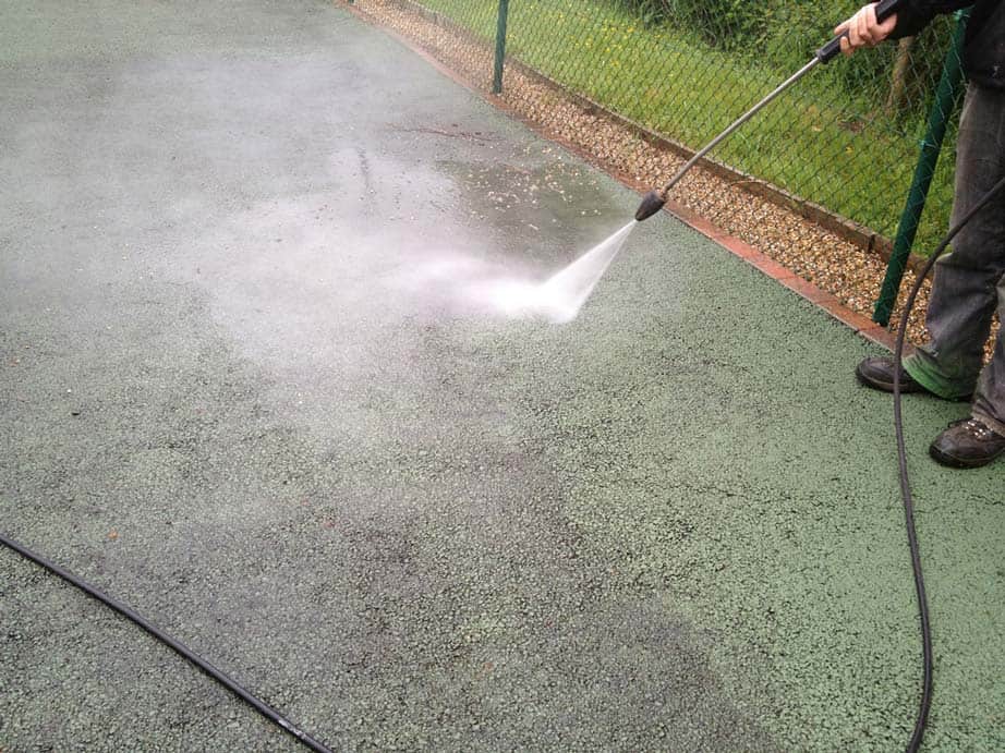 Court solutions performing tennis court cleaning by power washing